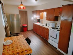 a small kitchen with a table and a refrigerator at Golden Sunflower's Apt E in Lawton