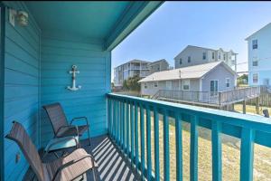 a balcony with two chairs and a cross on it at Beach Please* in Carolina Beach