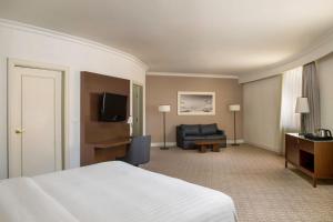 a hotel room with a bed and a couch at Armenia Marriott Hotel Yerevan in Yerevan