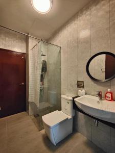 a bathroom with a toilet and a sink and a shower at Paragon Suites CIQ Homestay by WELCOME HOME in Johor Bahru