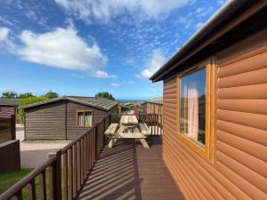 a deck on the side of a house at Surf Lodge in West Down