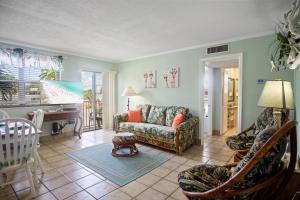 a living room with a couch and a table at Majestic Beach Condo with Heated POOL in St Pete Beach in St Pete Beach