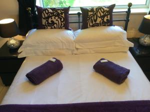 a bed with two pillows on top of it at The Golden Lion Hotel in Middlewich