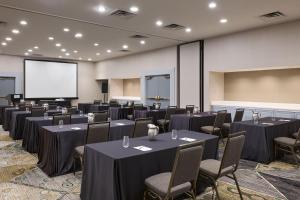 a conference room with tables and chairs and a screen at Marriott Columbus Northwest in Dublin