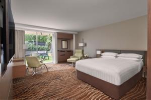 a hotel room with a bed and a desk and chairs at Melbourne Marriott Hotel in Melbourne