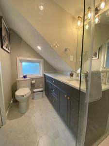 a bathroom with a toilet and a sink and a staircase at New Modern Three-room Duplex-2793 in Vancouver