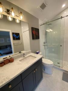 a bathroom with a sink and a shower and a toilet at New Modern Three-room Duplex-2793 in Vancouver