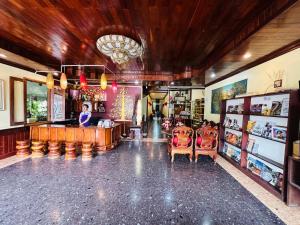 a room with two chairs and a bar in a store at Visoun Luang Prabang Hotel in Luang Prabang