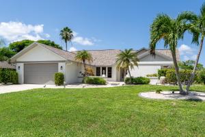 a house with palm trees in a yard at Beautiful Private Pool Home In-between Fort Myers Beach and Sanibel Island home in Fort Myers