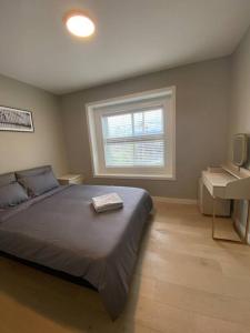 a bedroom with a large bed and a window at New Modern Theee-room Duplex-2791 in Vancouver