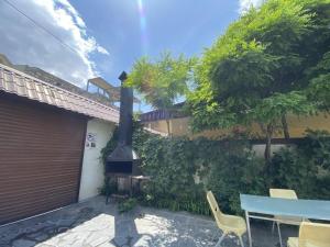 a patio with a fireplace and a table and chairs at Large 5 bedroom VIP Villa 2 in Yerevan