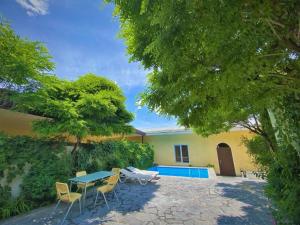 a patio with a table and chairs and a pool at Large 5 bedroom VIP Villa 2 in Yerevan