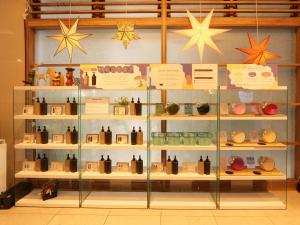 a display case in a store filled with lots of vases at The BREAKFAST HOTEL Fukuoka Nakasu in Fukuoka