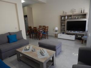 a living room with a couch and a table at Vera City Apartment in Zakynthos