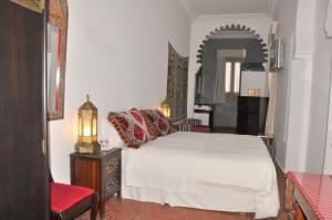 Uma cama ou camas num quarto em Hotel Blanco Riad