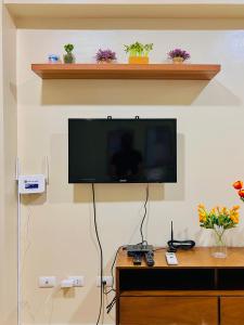 a flat screen tv hanging on a wall at * * *N Affordable Urban Luxury in Iloilo City +12 photos