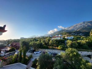 a view of a city with mountains in the background at Augustus Hotel in Dhërmi +35 photos
