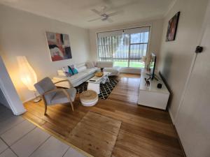 a living room with a couch and a table at Blue House on Murray River in Cobram