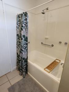 a bathroom with a shower and a bath tub at Blue House on Murray River in Cobram