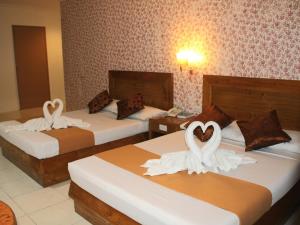 Postel nebo postele na pokoji v ubytování Rosas Garden Hotel