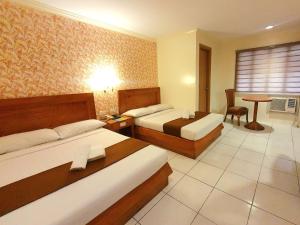 Postel nebo postele na pokoji v ubytování Rosas Garden Hotel