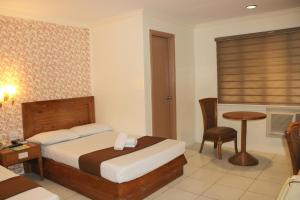 Postel nebo postele na pokoji v ubytování Rosas Garden Hotel