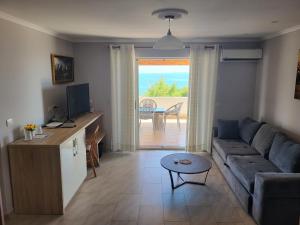 a living room with a couch and a table at Augustus Hotel in Dhërmi