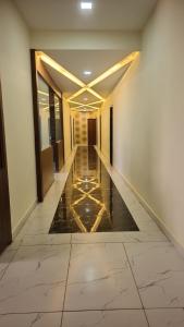 a hallway of a building with a tile floor at Hotel holiday residency in Sāgwāra