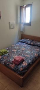 a bed with two pillows on it in a bedroom at Dimitris Afytos Apartment in Afitos