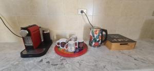 a counter top with a coffee maker and a blender at Beit El Ezz - la maison in Ouled Yaneg