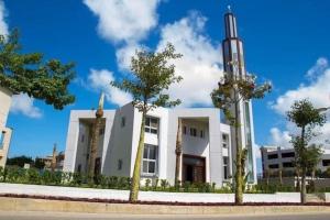 a white building with palm trees in front of it at North coast sedra resort villa قريه سيدرا الساحل الشمالي in Alexandria