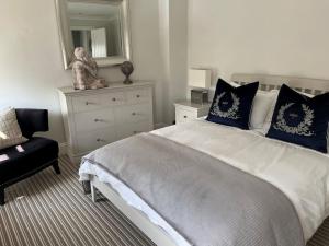a bedroom with a large bed with a teddy bear on it at Beautiful Seafront Studio Apartment in Cleethorpes