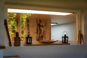 a mirror on a counter with two candles on it at Cabane pour vos vacances à 190m du lac d’Annecy in Menthon-Saint-Bernard