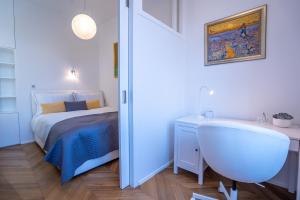 a small bedroom with a bed and a bath tub at Downtown Luxury Retreat in Ljubljana