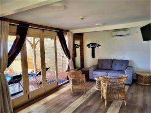 a living room with a couch and chairs at Hôtel Hamaha Beach in Mamoudzou