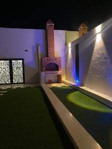 a rendering of a house with a fireplace and grass at شاليهات دار الورد in Taif