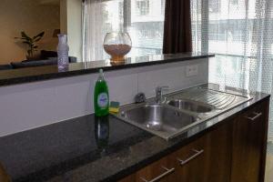 a kitchen counter with a sink and a wine glass at européenne union résidence in Brussels