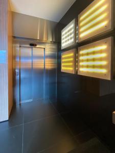 a bathroom with a door and some windows at européenne union résidence in Brussels