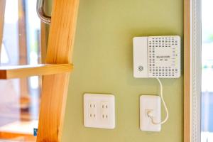 a wall with an electrical box on the wall at Piilo asobi&stay in Yamanakako