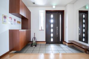a hallway with a door in a building at THE VILLA FURANO【Wide Horizon】 in Furano