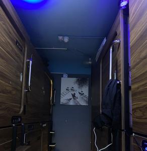 a hallway with wooden cabinets and a blue ceiling at Sleep Cubee Hostel in Hong Kong