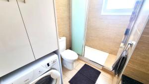 a small bathroom with a toilet and a shower at Dream Escape Apt 1 - 6 min walk to Kastella Beach! in Larnaka +7 photos