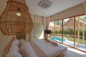 a bedroom with a bed and a large window at Hideout Koh Kood in Ko Kood