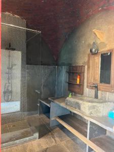 a bathroom with a shower and a sink and a counter at Nassimah in Giza