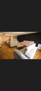 a large living room with couches and tables at Centro Catedral Carrera 27, 1 plaza de aparcamiento y NETFLIX gratis in Jaén