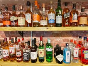 a shelf filled with lots of bottles of alcohol at Ashton Court Hotel in Exmouth
