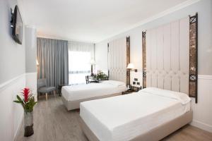 Postel nebo postele na pokoji v ubytování Hotel Gran Via + 37 fotografií