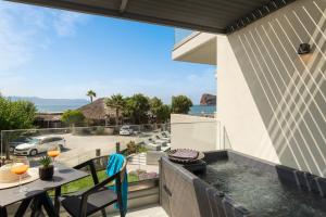 a hot tub on the balcony of a house at Elia Agia Marina Resort in Agia Marina Nea Kydonias