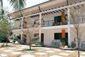 a building with trees in front of it at Maria Aliyah Events and Resort in Santa Cruz