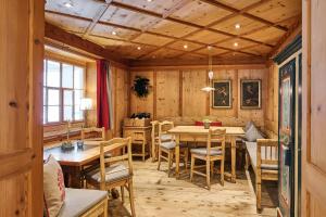 a dining room with wooden walls and a table and chairs at Hotel Garni Sursilva in Lech am Arlberg